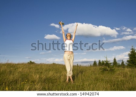 Young woman reaching to the sky