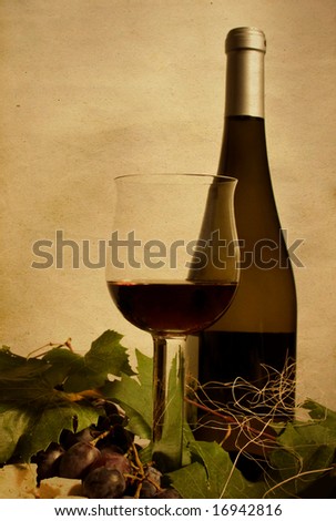 Cup and bottle of wine with grapes
