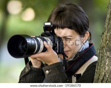 Young female photographer in forest