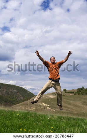 Young handsome man jumping for joy