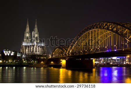 Koln - April 2: Night shot of Cologne dom and Hohenzollern bridge April 2, 2009 in Cologne, Germany