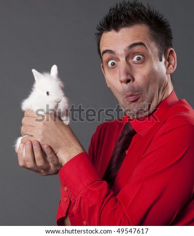 Funny man with white baby rabbit