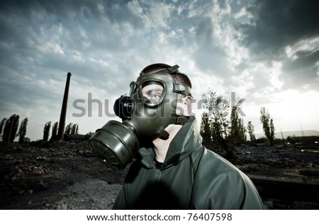 Bizarre portrait of man wearing gas mask