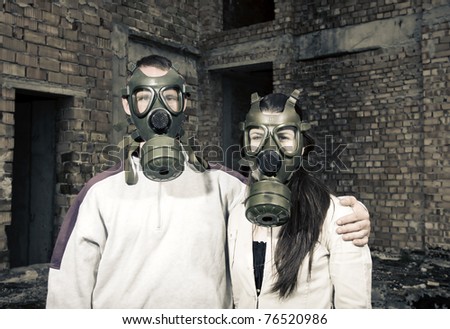Bizarre portrait of romantic couple with gas masks