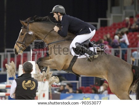 BUDAPEST, HUNGARY - DECEMBER 2: An unidentified competitor jumps with his horse at the OTP Equitation World Cup, December 2, 2011 in Budapest, Hungary