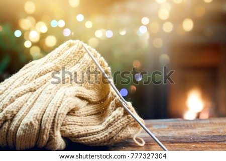 warm woolen knitwear and burning fireplace - cozy winter at home