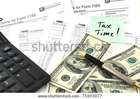 Tax Time. Concept Image with calculator, money and tax return forms as a background