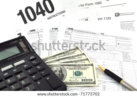 Tax Season! The  Concept Image with a calculator, money and tax return forms.