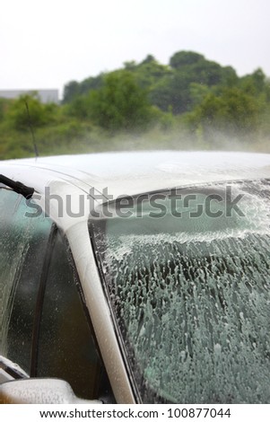 a car wash with a jet of water and shampoo