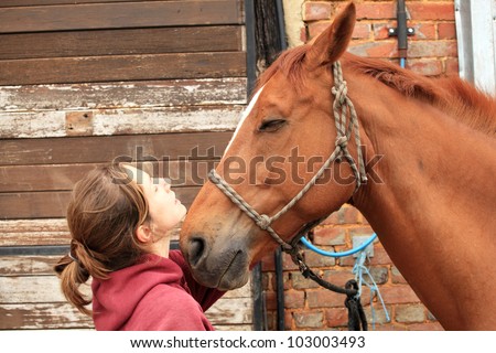 Beautiful women give an apple to her horse.