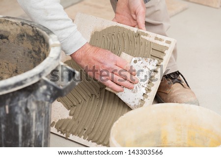 a tiler laying a tiled marble