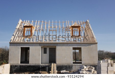 house under construction with the roof structure of wood