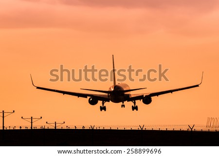 Jet Landing on an Airport Runway at Sunset