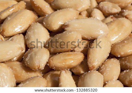 Peeled almonds,nuts - fried and peeled salted almonds on the plate