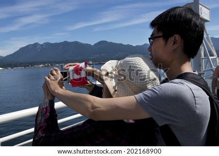 VANCOUVER CANADA DAY - JULY 1, 2014:Celebration of the National Day is provided across country, also in Vancouver. Three colonies were united in 1867 under Constitution Act into a single country called Canada