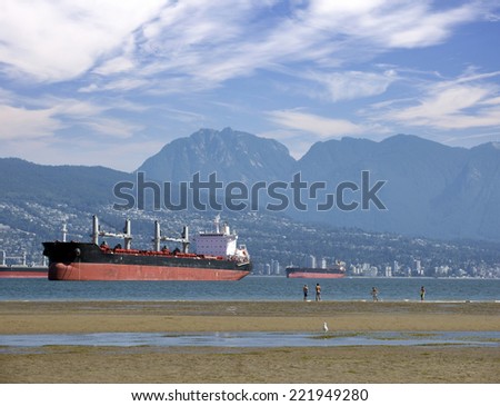 Vancouver, English Bay - wide Spanish Banks beaches with with two oceangoing freighter