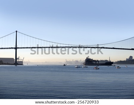 Vancouver, Lions Gate Bridge with fishing boats and trans-ocean transporter, British Columbia, Canada