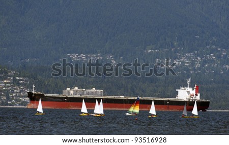 Sailing boats and large vessel on the sea