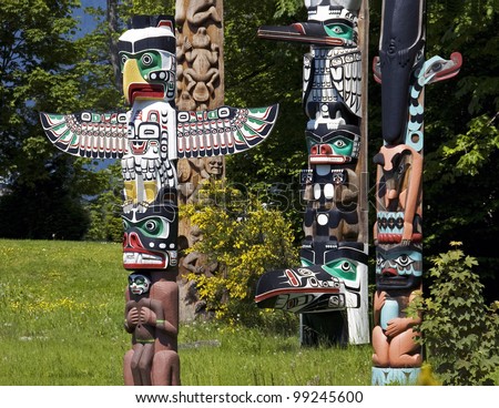 VANCOUVER, B.C. - MAY 22: Totem Poles in Stanley Park, the recurring symbols of the area indigenous population, are popular Vancouver's attraction. May 22, 2007 in Vancouver, British Columbia. - stock photo