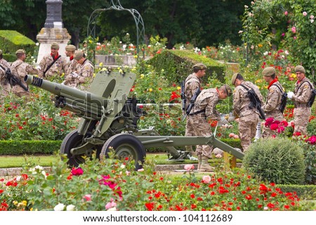 VALLADOLID, SPAIN- JUNE 2: Group of soldiers loading a cannon in a garden in the Armed Forces Day 2012, on June 2, 2012 in Valladolid, Spain.