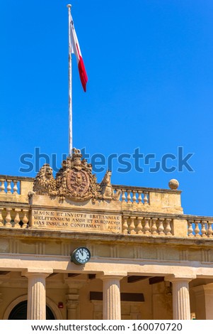 Detail of the carving and the flag in the roof of the Main Guard building in Valletta.