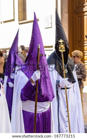VALLADOLID, SPAIN -Â?Â? APRIL 17, 2014: Typical purple nazarenos in the religious processions during Holy Week on Good Thursday, on April 17, 2014 in Valladolid, Spain.
