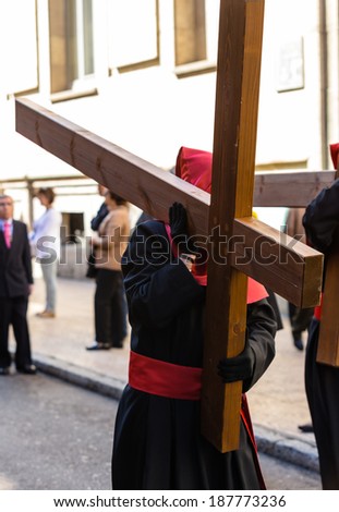 VALLADOLID, SPAIN -Â?Â? APRIL 17, 2014: Nazareno carrying a cross in the religious processions during Holy Week on Good Thursday, on April 17, 2014 in Valladolid, Spain.