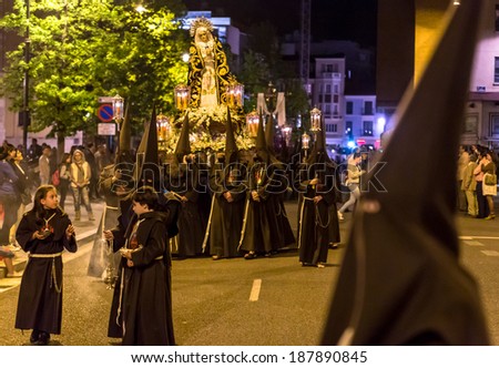 VALLADOLID, SPAIN -Â?Â? APRIL 17, 2014: Nazarenos carrying Virgin sculpture in the religious processions during Holy Week on Good Thursday Night, on April 17, 2014 in Valladolid, Spain.