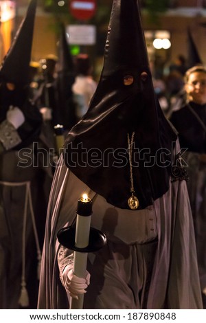 VALLADOLID, SPAIN -Â?Â? APRIL 17, 2014: Nazareno carrying a candle in the religious processions during Holy Week on Good Thursday Night, on April 17, 2014 in Valladolid, Spain.