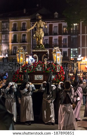 VALLADOLID, SPAIN -Â?Â? APRIL 17, 2014: Nazarenos carrying Jesuschrist sculpture in the religious processions during Holy Week on Good Thursday Night, on April 17, 2014 in Valladolid, Spain.