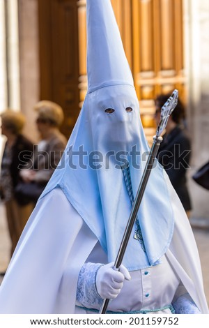 White and blue nazareno in the Good Thursday during Holy Week in Valladolid.