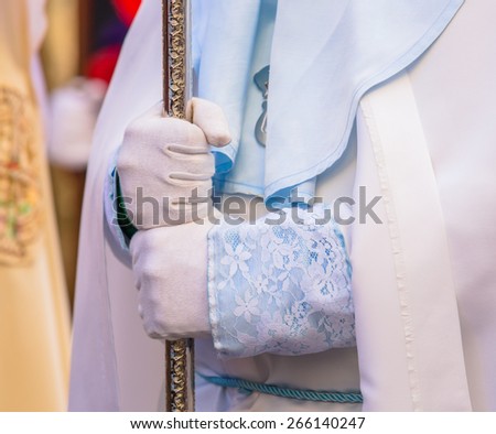 Nazareno holding a cross in his hands in the Good Thursday during Holy Week in Valladolid.