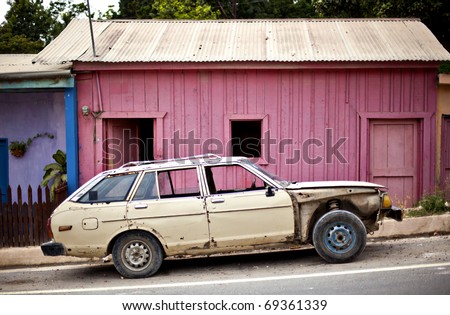 stock photo old car in front of pink building
