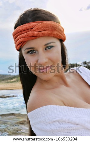 Beautiful young woman smiling at the beach