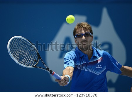 SYDNEY - JAN 8: Tommy Robredo from Spain hits a volley in his first round match in the APIA Sydney Tennis International. Sydney January 8, 2013.