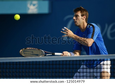 SYDNEY - JAN 11: Marcel Granollers volleys during his doubles semi final at the APIA Sydney Tennis International. Sydney January 11, 2013.
