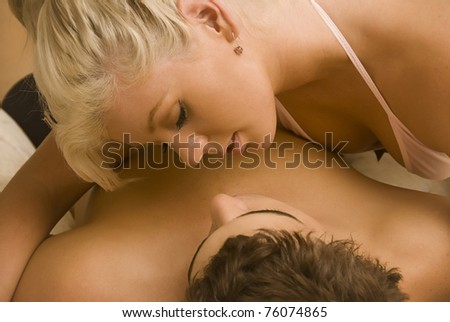 Lovers in bed about to kiss