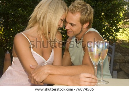 Attractive couple at garden cafe in love