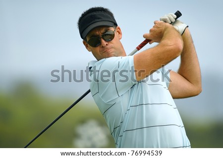 Male golfer tees off during his round