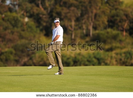 SYDNEY - NOV 11: - John Cook raises his knee in anticipation at the Emirates Australian Open at The Lakes golf course. Sydney - November 11, 2011