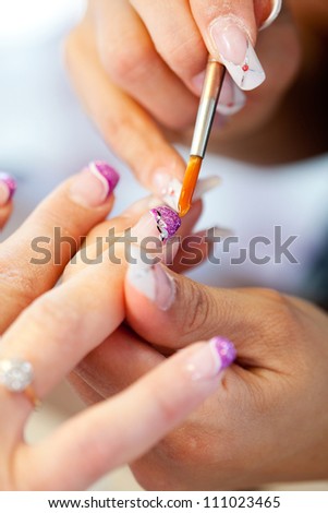 Woman getting artificial nails done, selective focus
