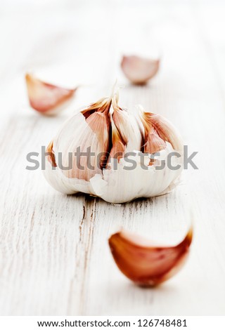 Fresh garlic on white wooden table, selective focus