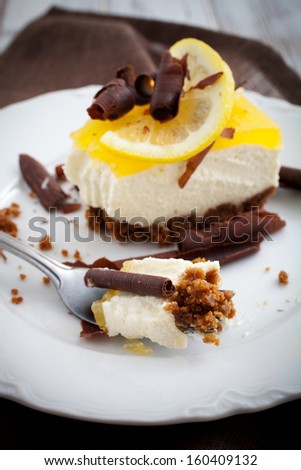 Lemon cheesecake with lemon slice and chocolate curls