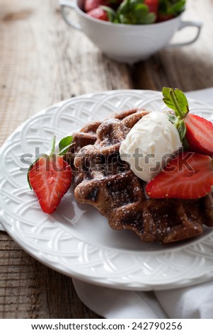 Belgian waffles with vanilla ice cream and strawberries
