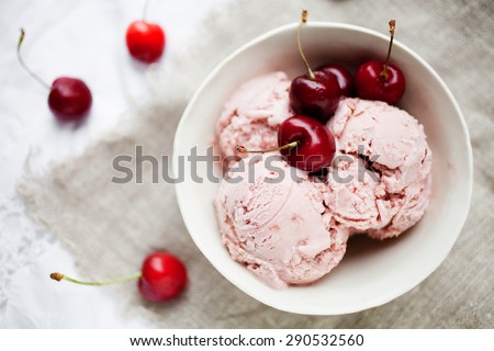 Homemade cherry ice cream on table