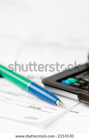 Pen and calculator top of financial statements
