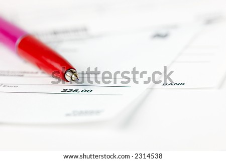 Red pen on top of financial statements
