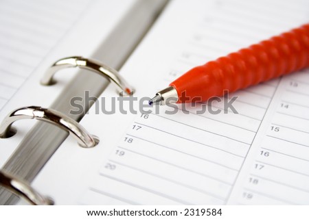 Red pen on top of blank calendar pages