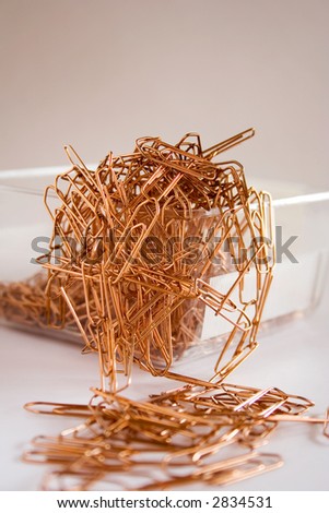 Lots of paper clips in transparent box