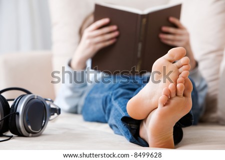 Teenager reading on the couch